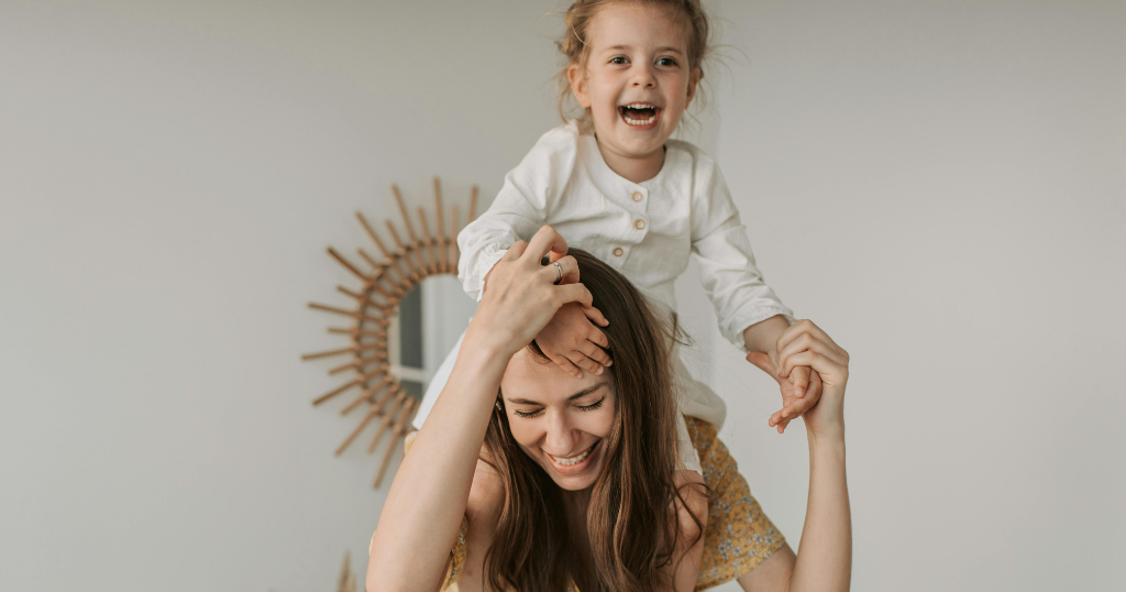 A mother playing with her child at home, illustrating how movement supports mood, energy, and emotional wellbeing in everyday family life.